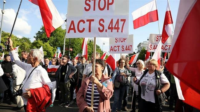 Trump signs compensation law,(reparations) Native Americans and Poles protest
